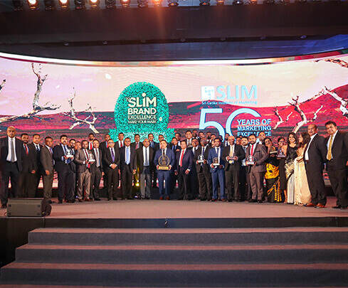 winners and committee members on stage for the slim brand excellence event