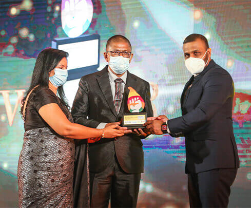 people handing over an award to the winner at SLIM brand excellence event